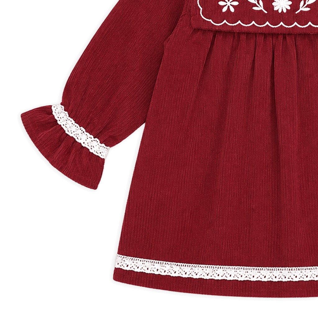 Red dress with white lace details on a black background