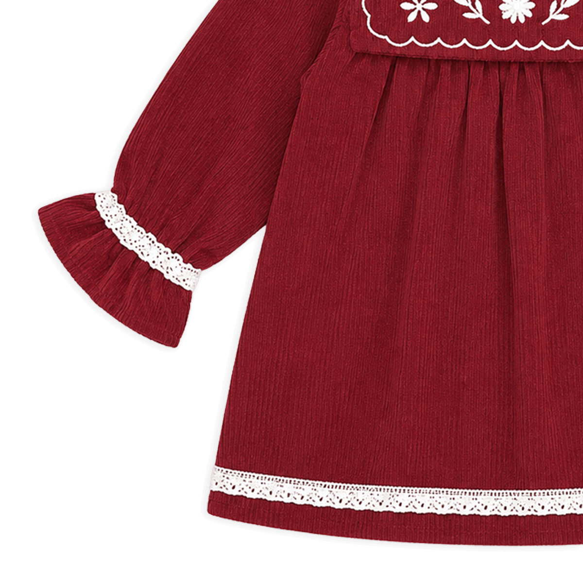 Red dress with white lace details on a black background