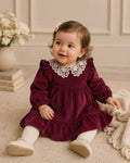 Toddler wearing corduroy raspberry dress