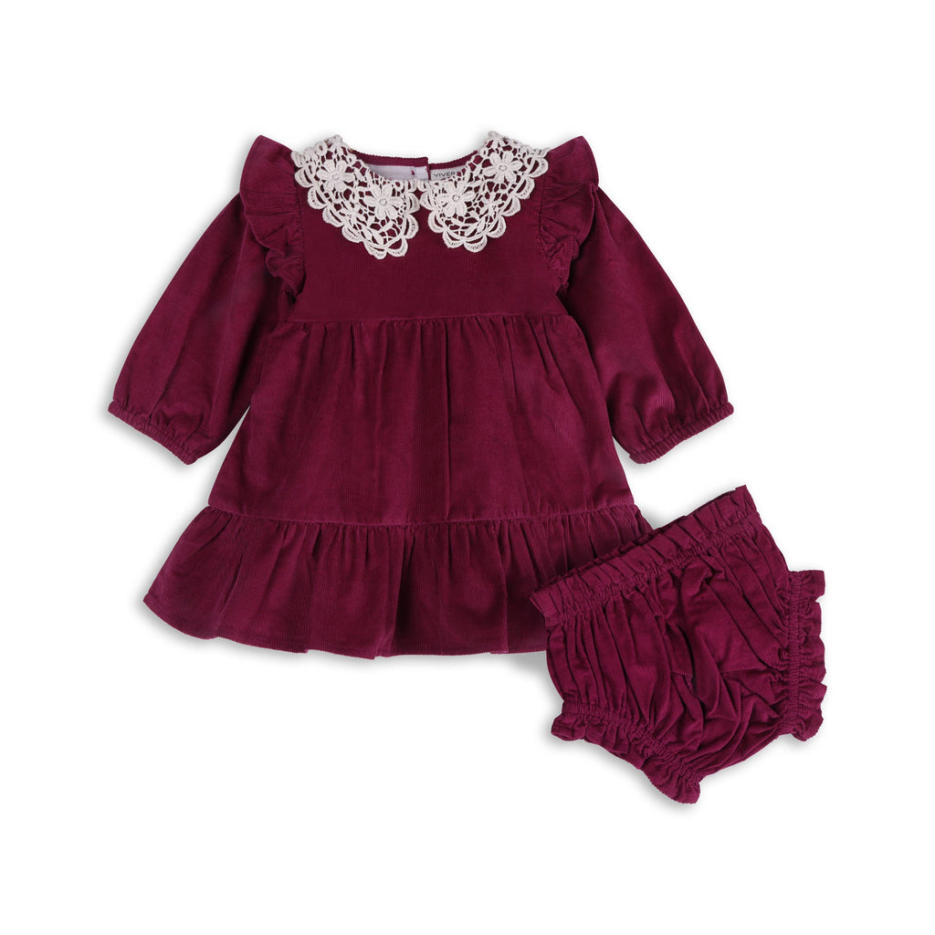 Corduroy raspberry dress for toddlers against white background. Lace collar detail.