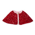 Red sequin Santa cape with white trim, a gold star fastening, and pink-and-white striped lining