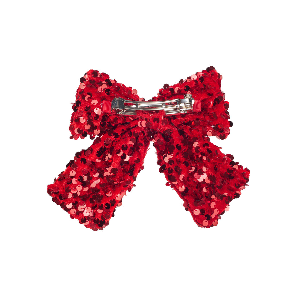back of red sequin bow on white background