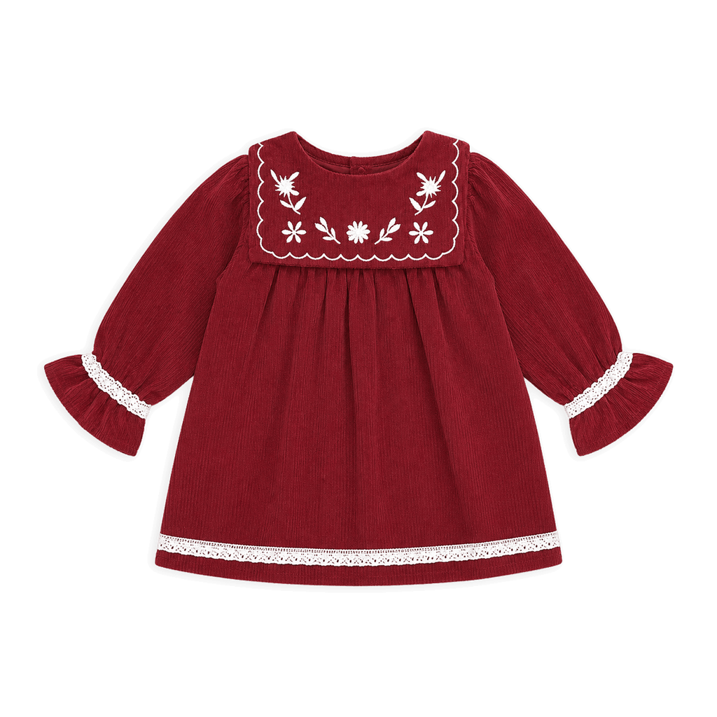 Red dress with white embroidery on a black background